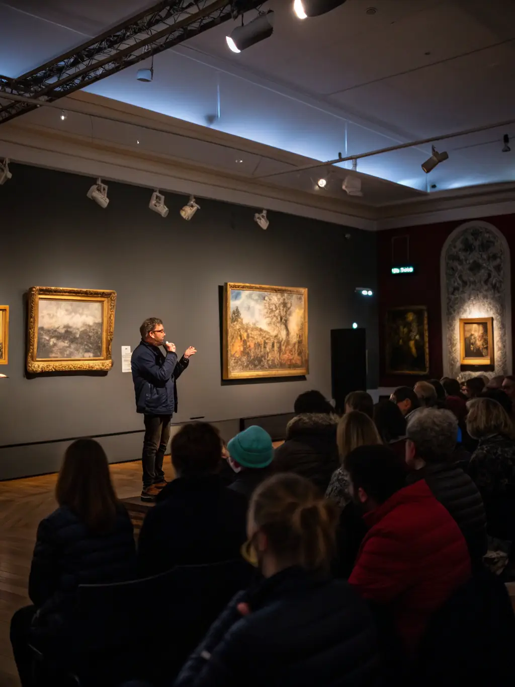 A photo of a guest lecturer giving a presentation on the history of faience pottery, with examples of historical pieces on display.